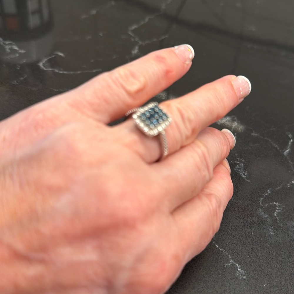 Small sapphire ring surrounded by diamonds.